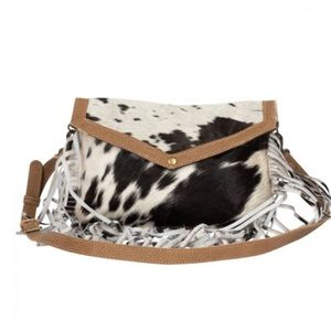 Crossbody cowhide leather bag with fringes.